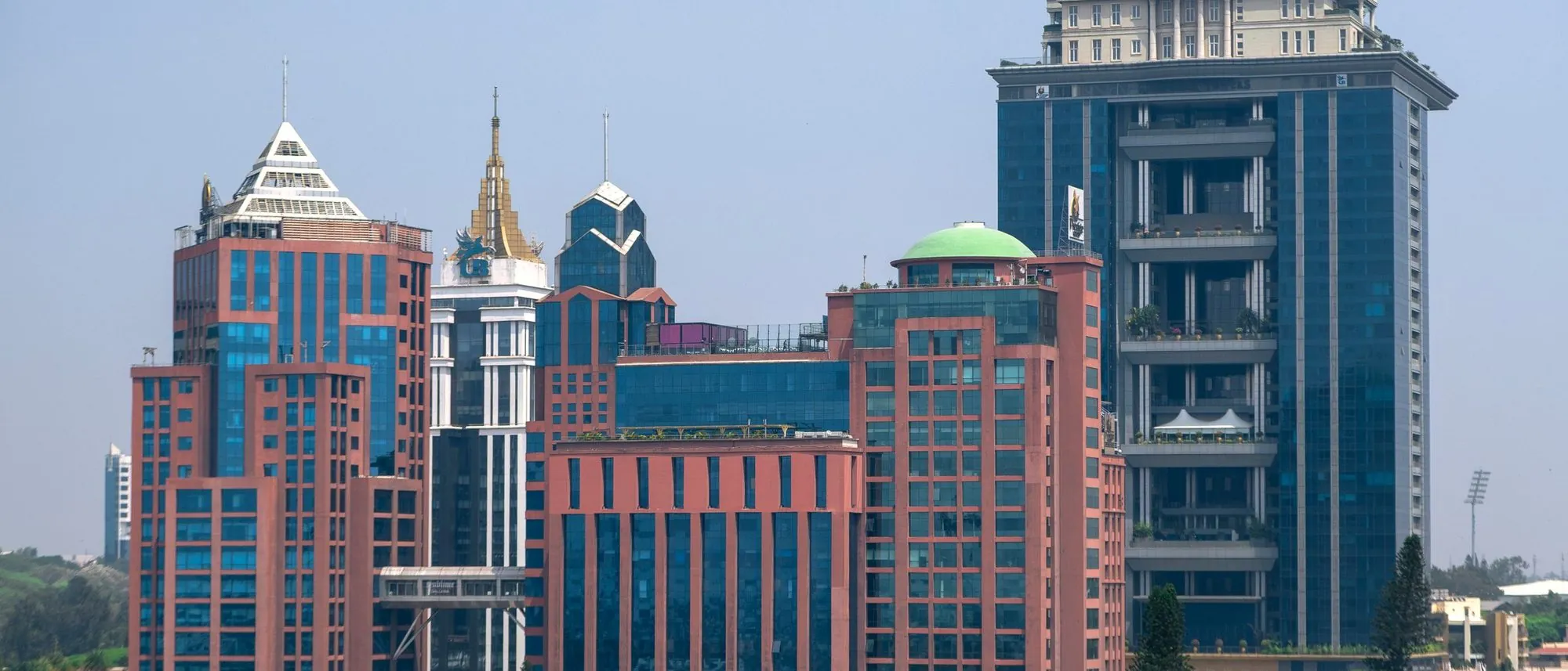 Modern glass towers in Bengaluru against a clear blue sky.
