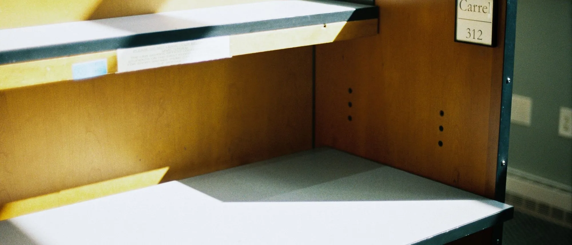 Morning sun across an empty wooden desk in a quiet office
