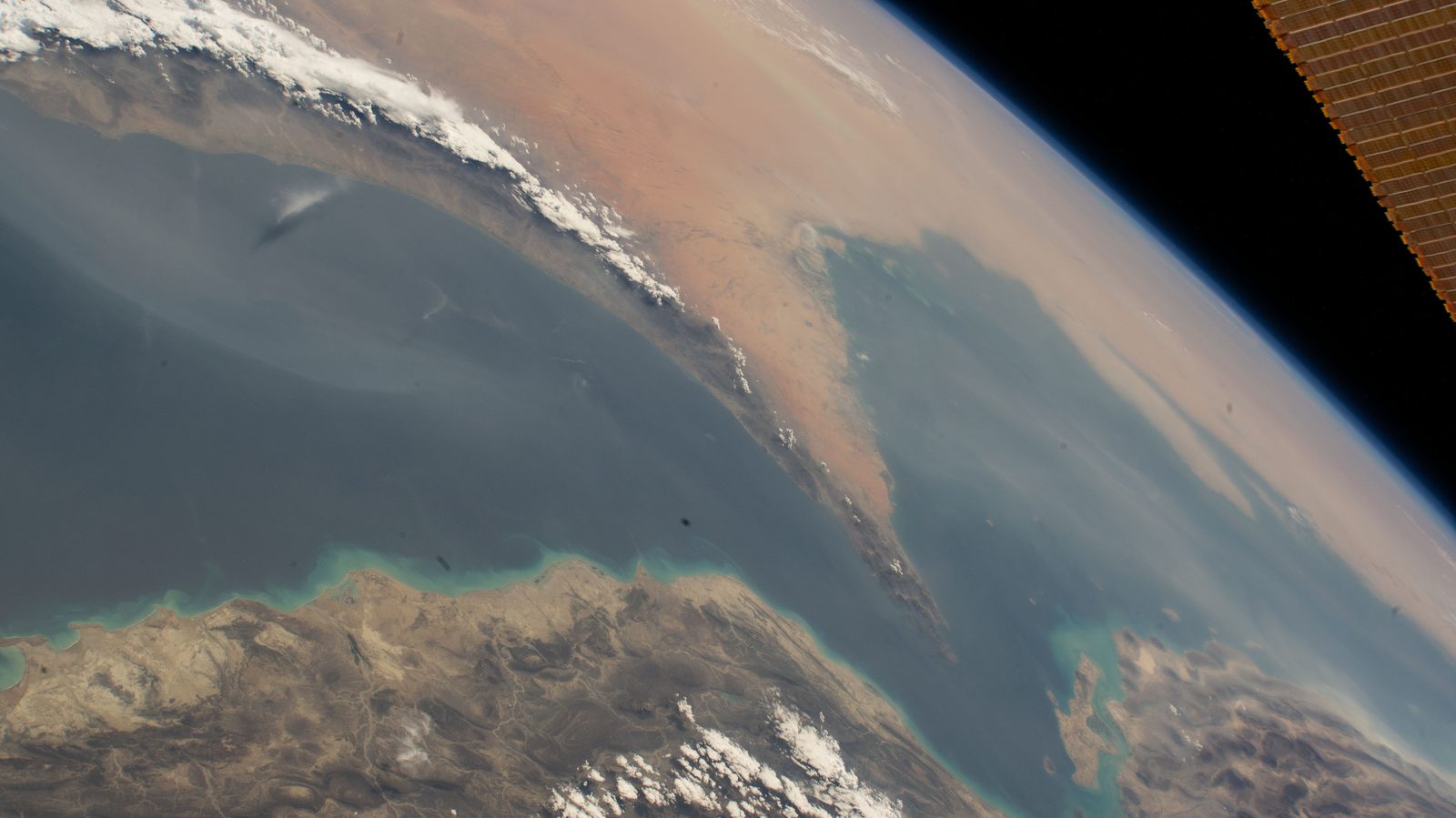 The Strait of Hormuz seen from the International Space Station, the narrow water between the Arabian Peninsula and Iran under the curve of the Earth