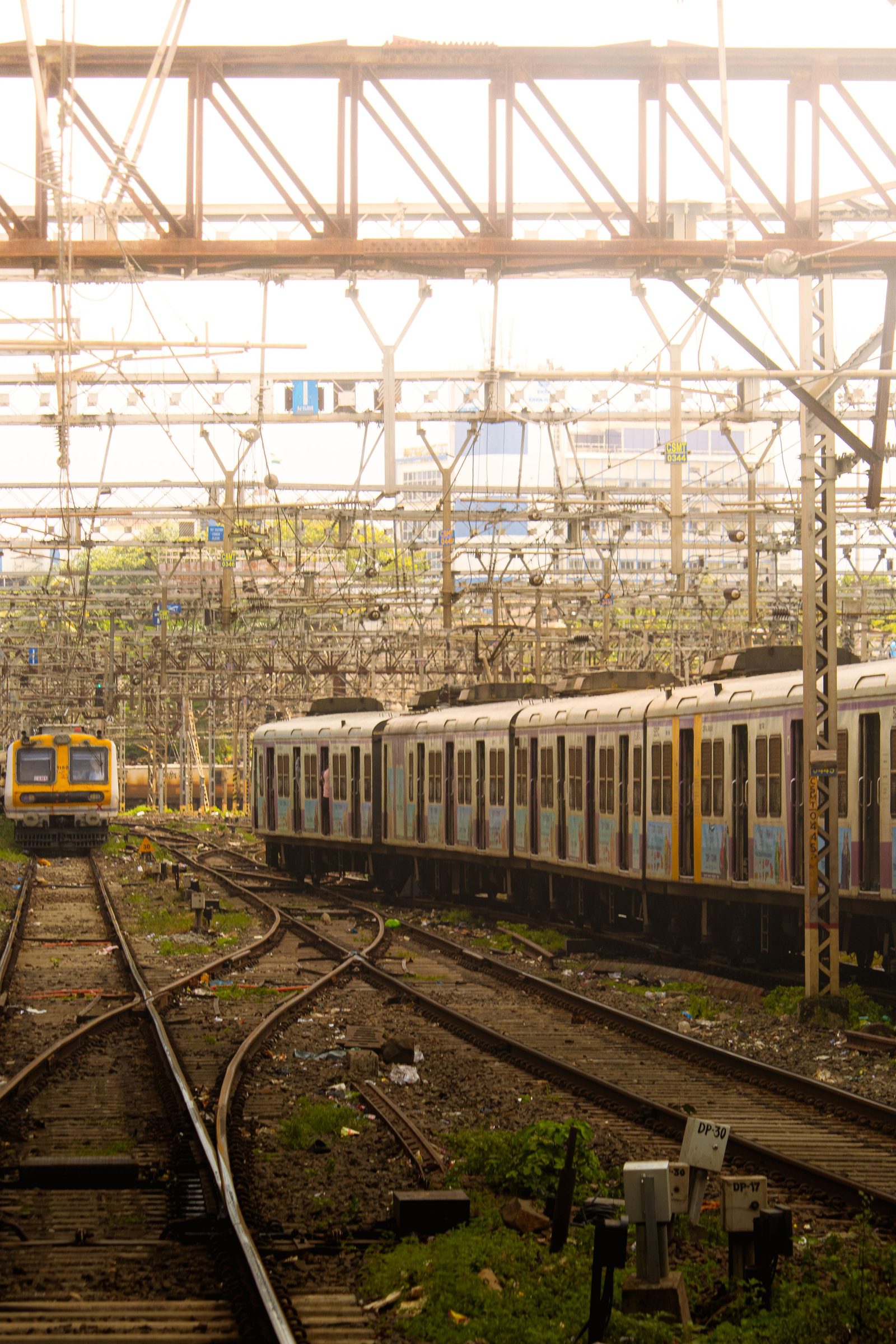 A Mumbai local train running along crowded tracks.