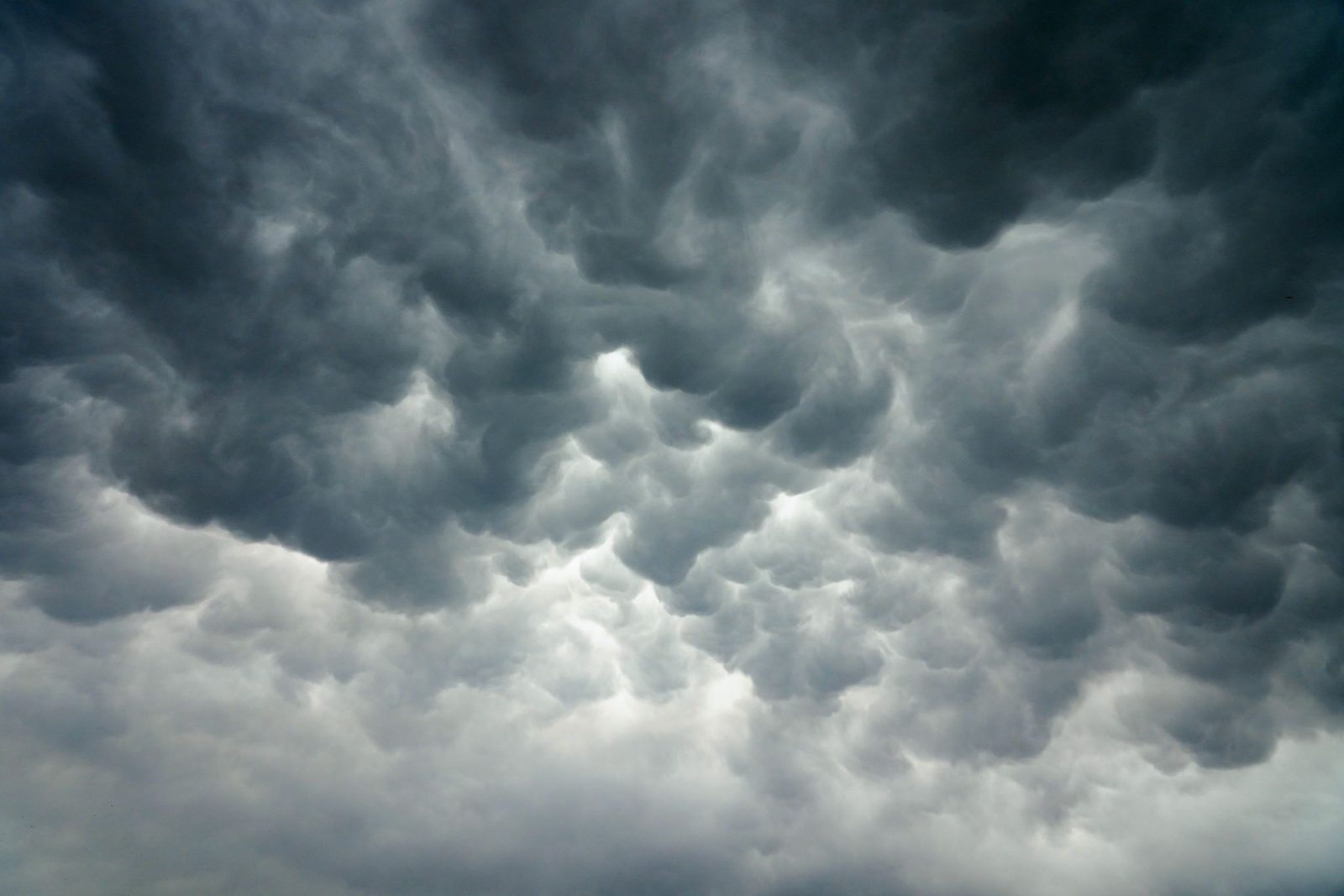 Dark low storm clouds gathering over open land at Sanand in Gujarat.