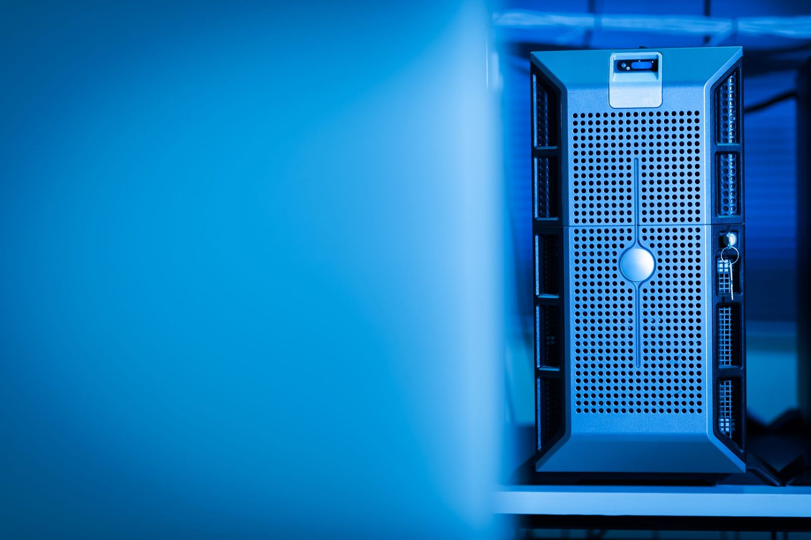A single server unit lit blue inside a data centre.