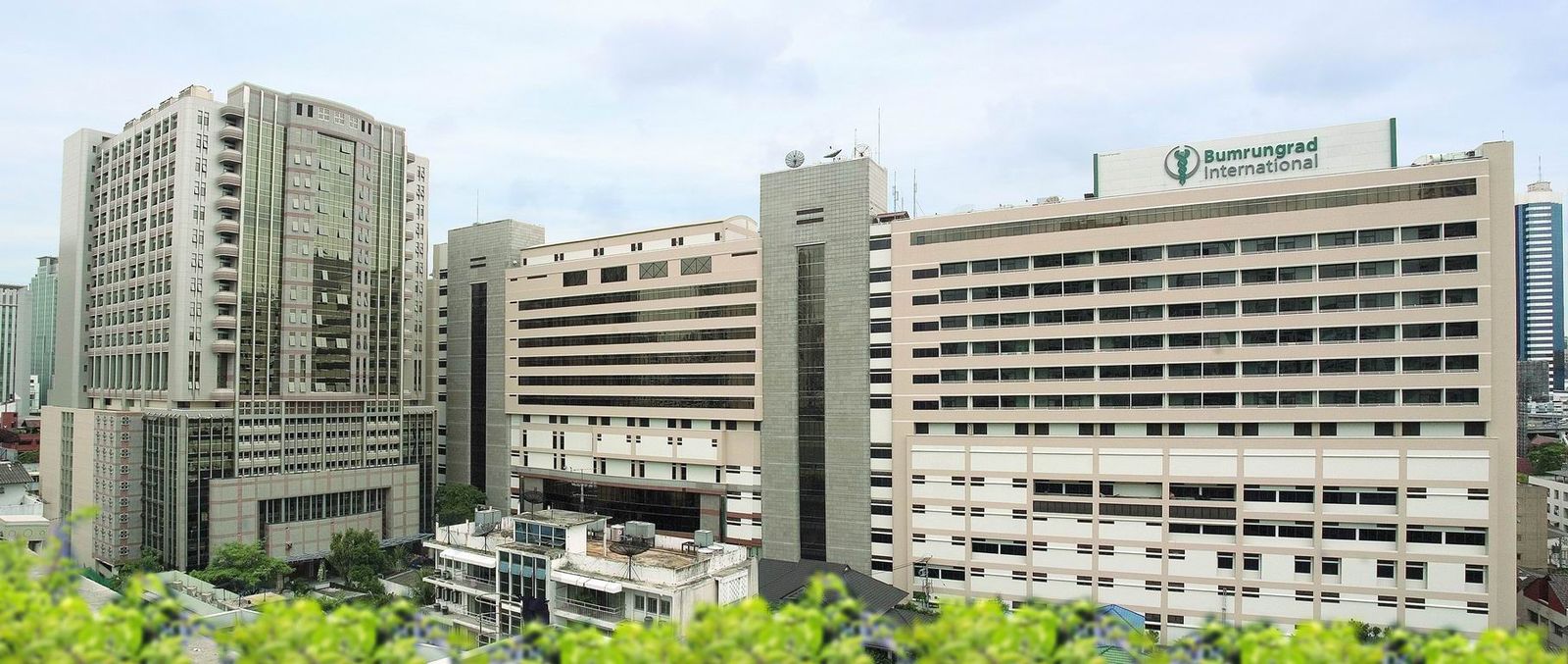 The tower blocks of Bumrungrad International Hospital rising above central Bangkok
