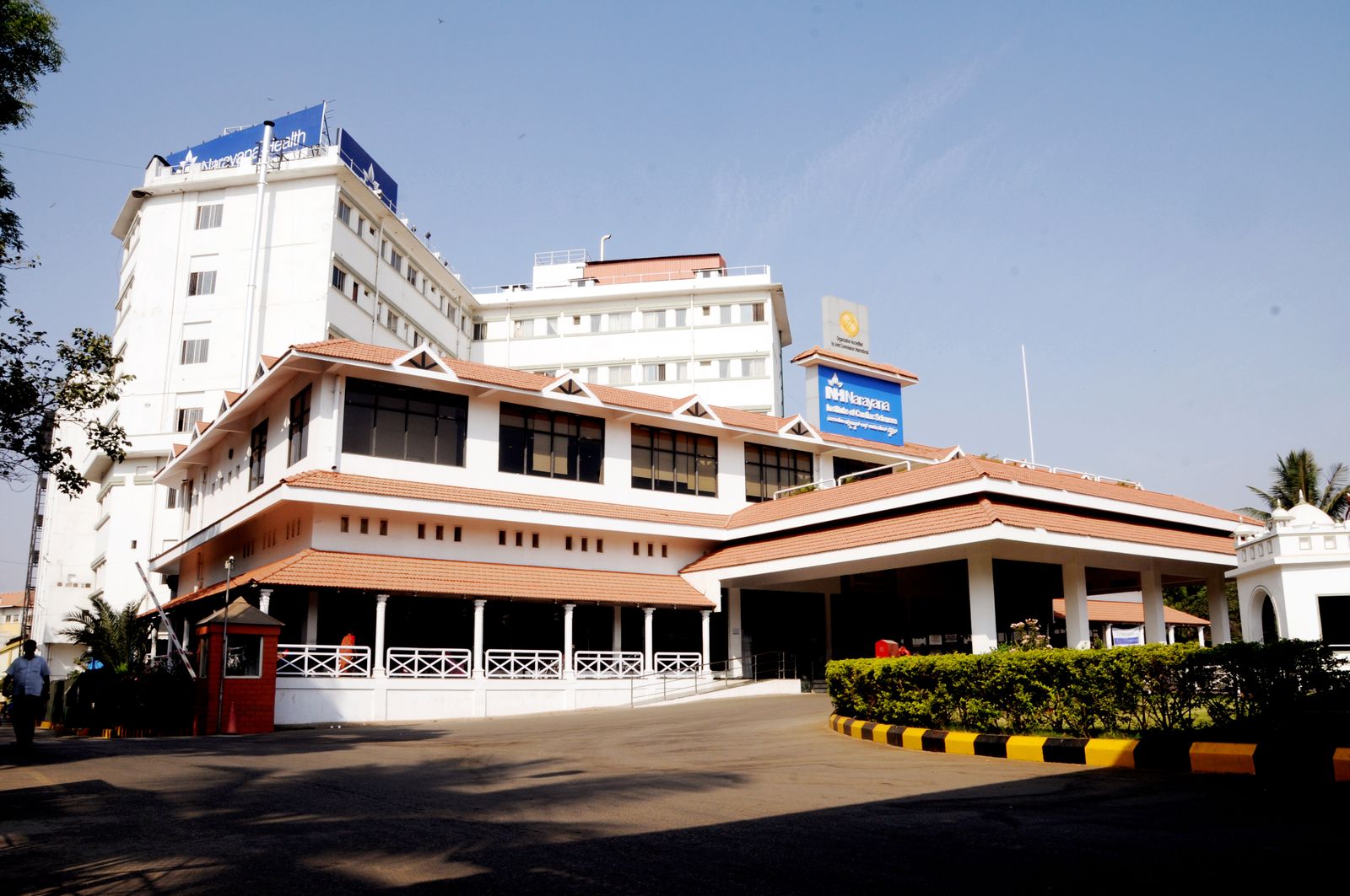 The white and red-roofed exterior of the Narayana Institute of Cardiac Sciences in Bengaluru