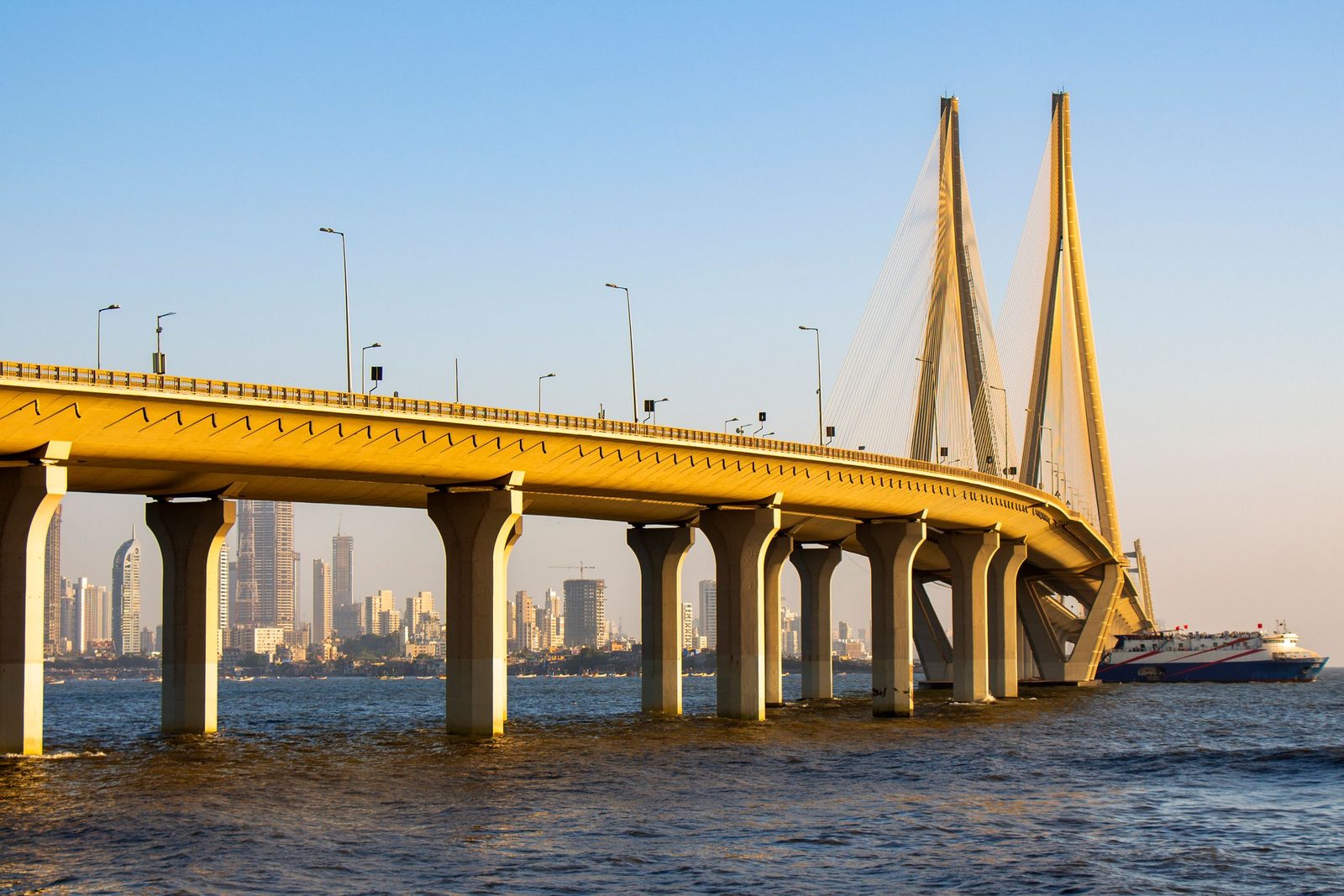 The Bandra-Worli Sea Link crosses the water towards the Mumbai skyline at sunset.