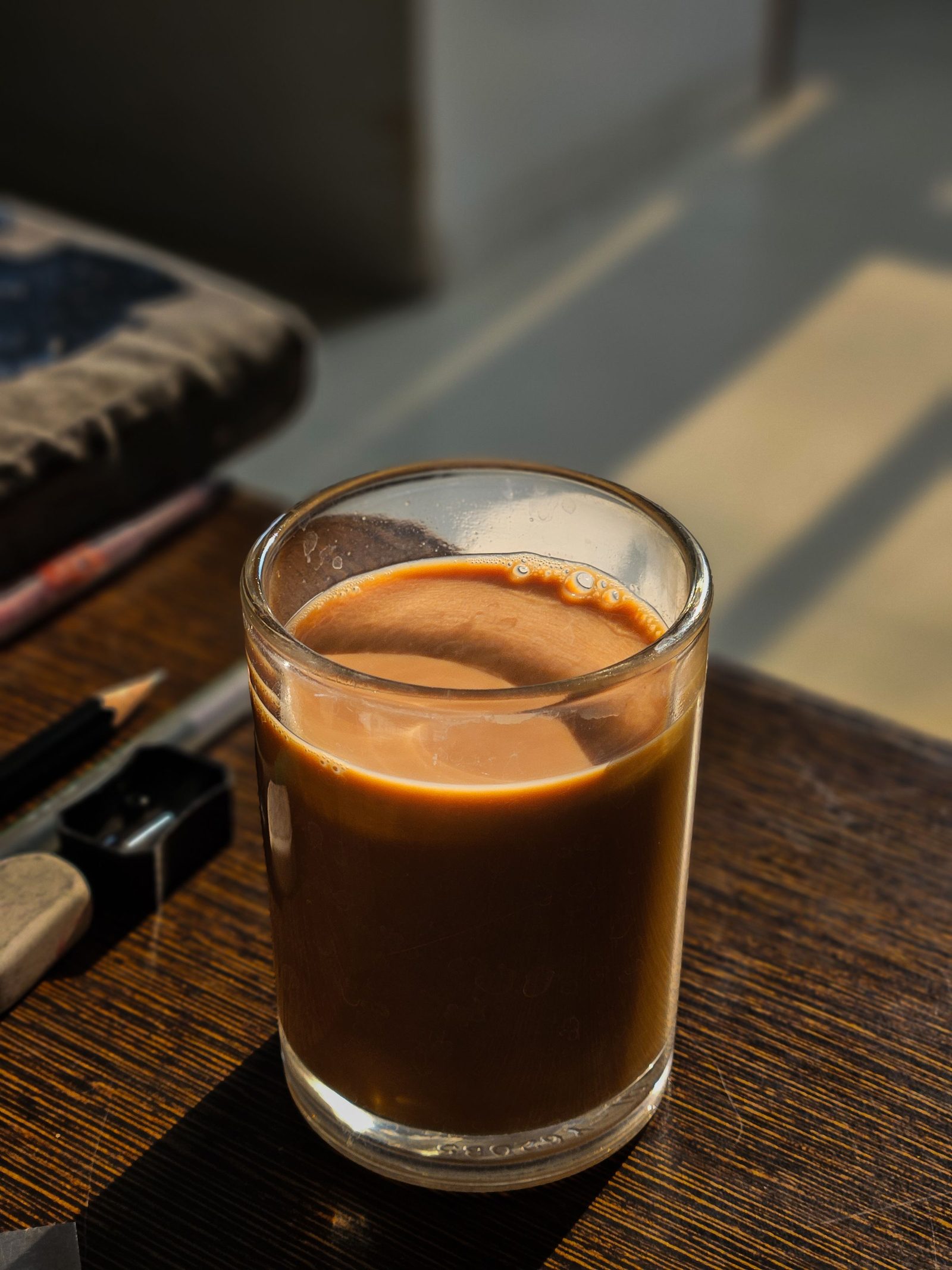 A steaming glass of masala chai on a sunlit table in Bengaluru.