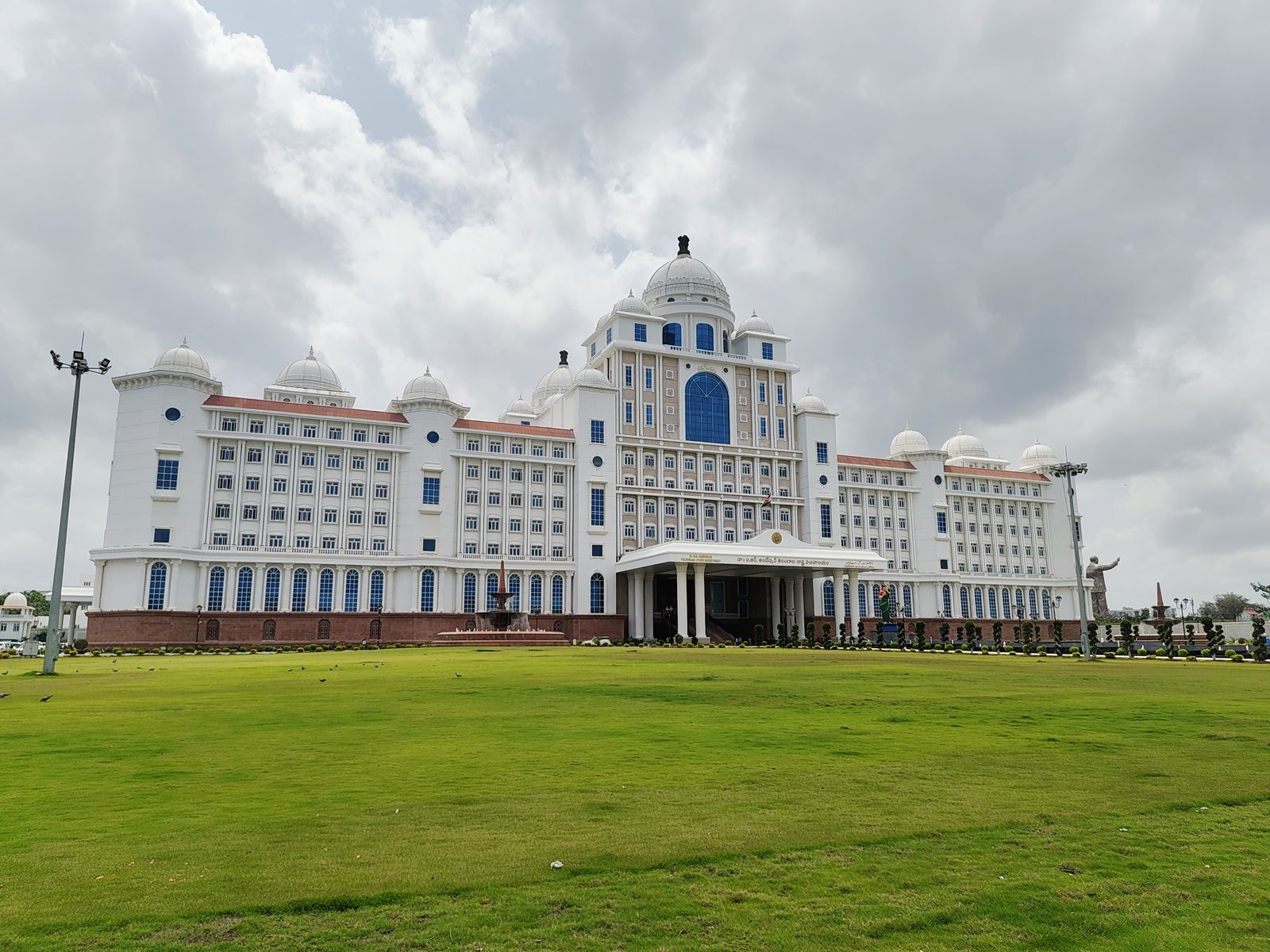 The white domed Telangana State Secretariat in Hyderabad seen across its front lawn