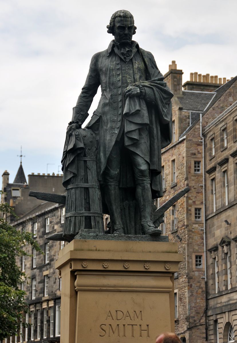 The bronze statue of Adam Smith on its stone plinth on the Royal Mile, Edinburgh