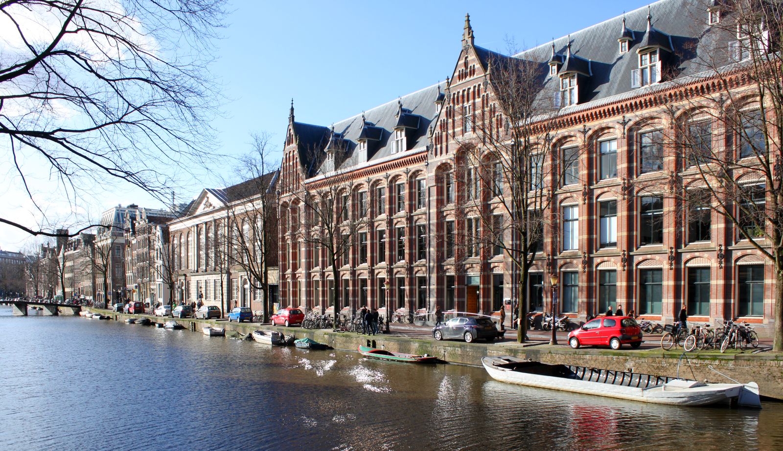 The brick facade of the Oost-Indisch Huis on a canal in Amsterdam