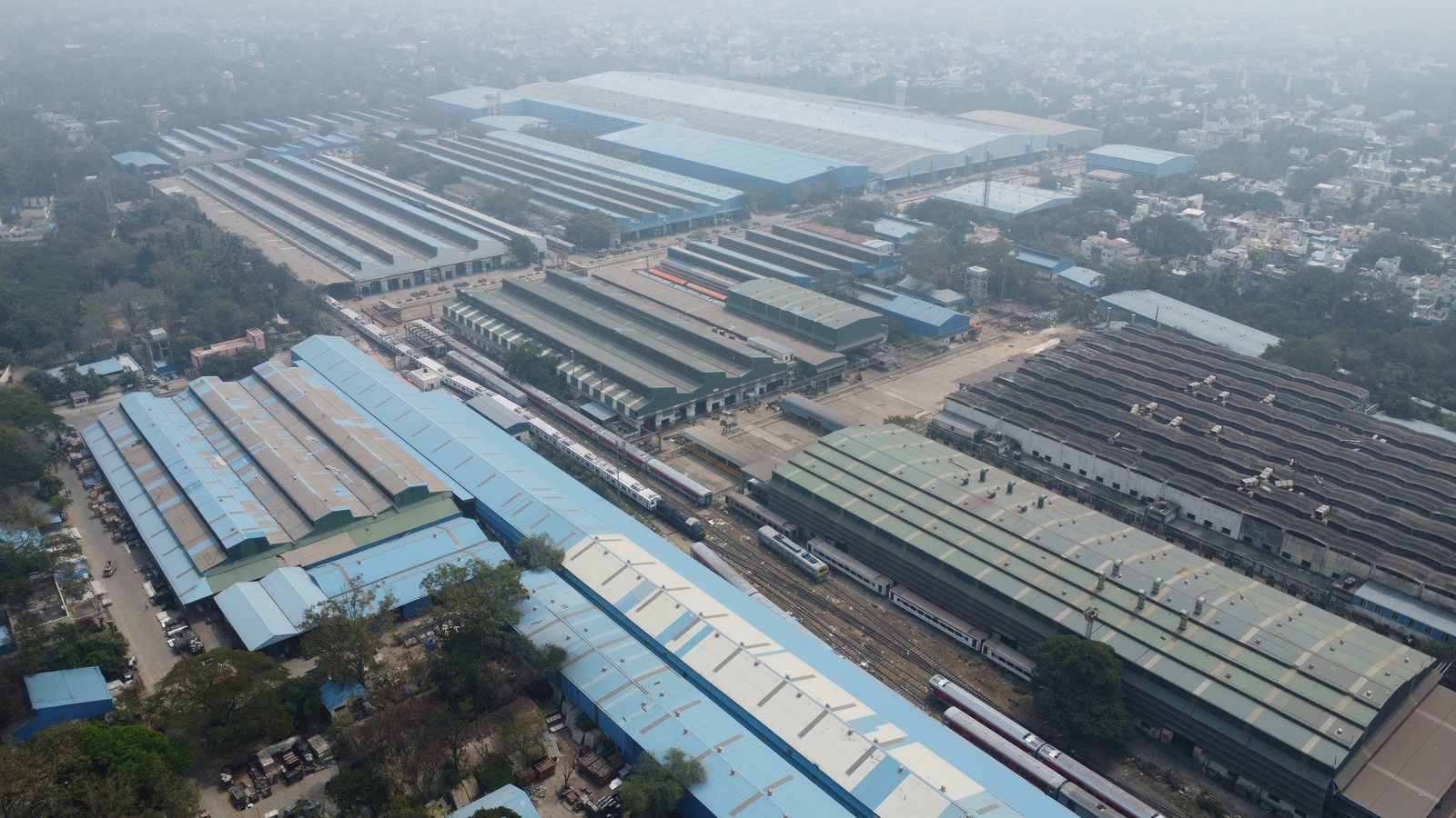 Aerial view of the long blue and grey sheds of the Integral Coach Factory in Chennai