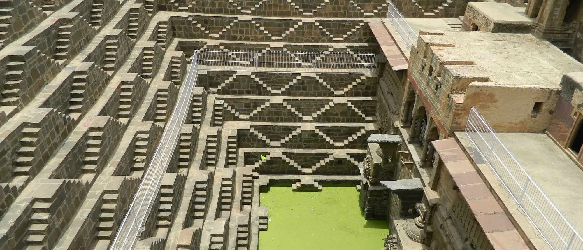 Aerial view of the geometric stone steps of Chand Baori stepwell in Abhaneri, Rajasthan.
