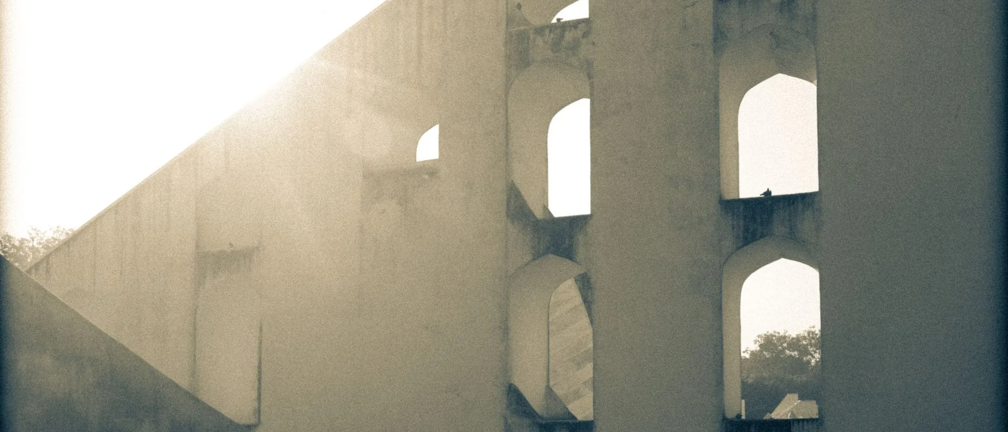 The stone instruments of the Jantar Mantar observatory in Jaipur in bright sunlight.